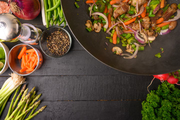 Culinary background, frying meat with vegetables. With space.
