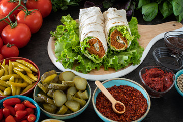 Cig kofte (raw meatball in Turkish) with lettuce, tomato, pickle and lemon, hot Chee kofta