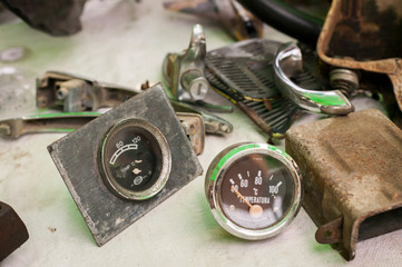 A couple of old manometers are seen, among handle lochs and other stuff, on a table in a local...