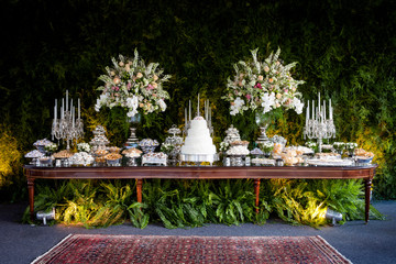 An elegant and impressive cake and candy  table for a wedding