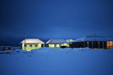 types of snow-covered village on a polar night in the Russian Arctic