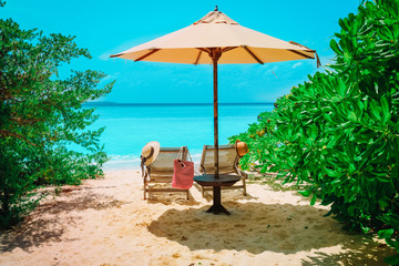 Two beach chairs on tropical vacation, relax at sea