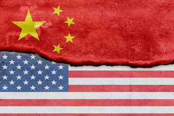 Flag of USA and China on cracked concrete wall background. Concept conflicts of two superpowers.