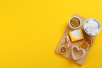 Obraz na płótnie Canvas Flat lay composition with natural handmade soap and ingredients on yellow background. Space for text