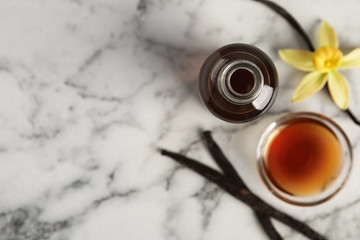 Homemade vanilla extract on marble table, flat lay. Space for text