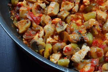 Sauteed chicken with mushrooms, tomatoes and onions.