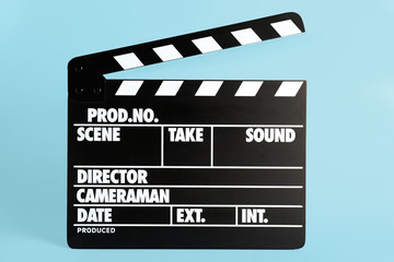 Fototapeta premium Clapper board on light blue background. Cinema production