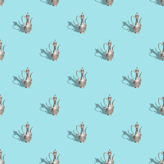 Seamless pattern with vintage old teapot on trendy blue background, isometric style