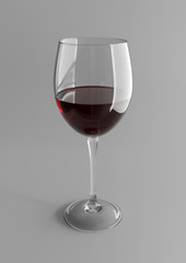 glass of red wine on gray background