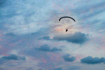 paramotor flight in horizontal sunset sky