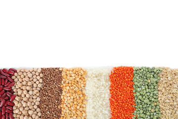 Different types of legumes and cereals on white background, top view. Organic grains
