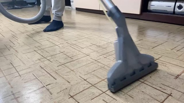 cleaning a wooden floor with a washing vacuum cleaner instead of mopping. Household chores doing concept 4k close up