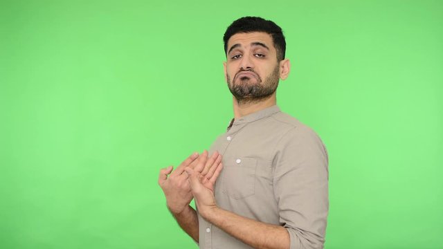 This is me! Arrogant brunette man with bristle in shirt pointing himself, looking haughty egoistic at camera, feeling self-important proud confident. indoor studio shot, green background, chroma key