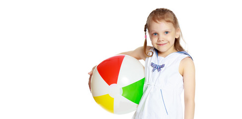 Little girl is playing with a ball