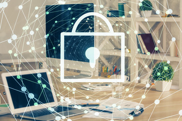 Double exposure of desktop with computer and lock icon hologram. Concept of data safety.