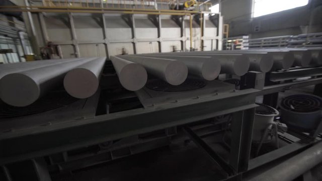 Automatic Aluminium extrusion production line in modern factory. Production of Complex lightweight extruded aluminium metal profiles, commonly used as material in construction and manufacturing