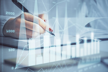 Multi exposure of woman's hands making notes with forex graph hologram. Concept stock market analysis.