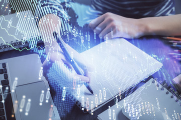 Financial chart drawn over hands taking notes background. Concept of research. Double exposure