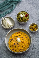 Makki ki roti with sarson ka saag, popular north indian main course menu usually prepared in winter season, using cornmeal breads and mustard leaves vegetables