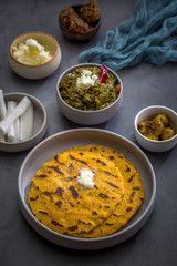 Makki ki roti with sarson ka saag, popular north indian main course menu usually prepared in winter season, using cornmeal breads and mustard leaves vegetables