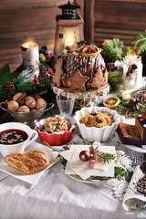 Christmas Eve table with traditional dishes and cakes