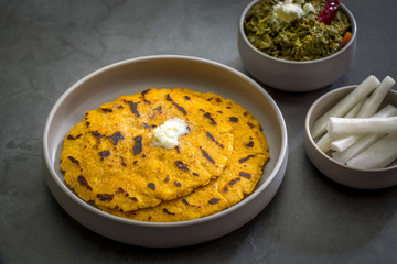 Makki ki roti with sarson ka saag, popular north indian main course menu usually prepared in winter season, using cornmeal breads and mustard leaves vegetables