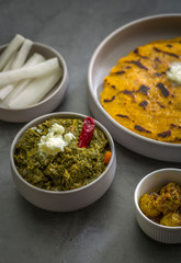 Makki ki roti with sarson ka saag, popular north indian main course menu usually prepared in winter season, using cornmeal breads and mustard leaves vegetables