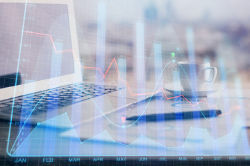 Forex graph hologram on table with computer background. Double exposure. Concept of financial markets.