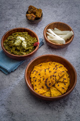 Makki ki roti with sarson ka saag, popular north indian main course menu usually prepared in winter season, using cornmeal breads and mustard leaves vegetables