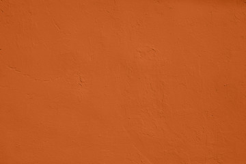 Saturated orange colored low contrast Concrete textured background with roughness and irregularities. 2020 color trend.