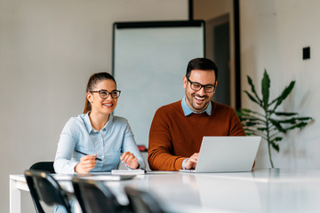 Happy businesspeople working together in the office