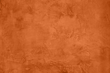 Saturated orange colored low contrast Concrete textured background with roughness and...