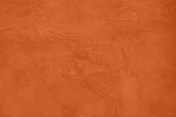 Saturated orange colored low contrast Concrete textured background with roughness and irregularities. 2020 color trend.