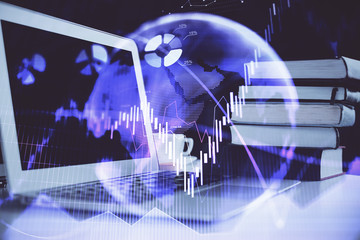 Stock market graph and table with computer background. Double exposure. Concept of financial analysis.
