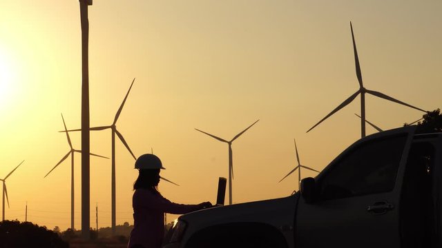 Engineers are monitoring the wind turbine system with a tablet footage 4K