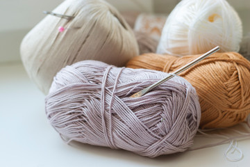 a ball of woolen thread and hook for crochet