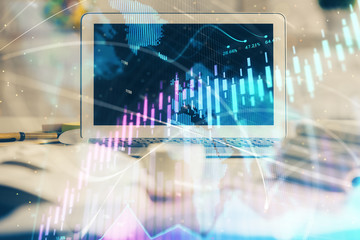 Forex market chart hologram and personal computer background. Double exposure. Concept of investment.