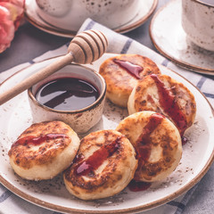 Delicious curd pancakes with fruit sauce. Breakfast or lunch concept. Toned photo