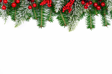 Christmas and New Year holidays background. Winter decorated backdrop. Snow fir tree, fir tree and red berries on white background. Top view with copy space. Part of set.