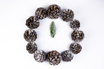 Christmas time concept. Mock Christmas clock and watch made of pine cone and fir branches. Holiday and New Year decoration