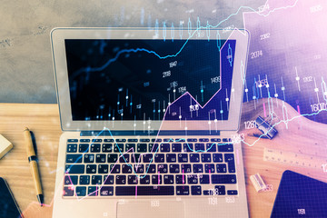 Double exposure of forex graph and work space with computer. Concept of international online trading.