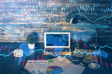 Double exposure of forex graph and work space with computer. Concept of international online trading.