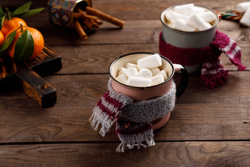 Christmas marshmallows in a drink Christmas decorations and tangerines on a wooden background. Winter holidays, new year mood. Copy space. Close up.