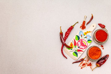 Magyar (Hungarian) red sweet and hot paprika powder. Traditional pattern on a cutting board,...
