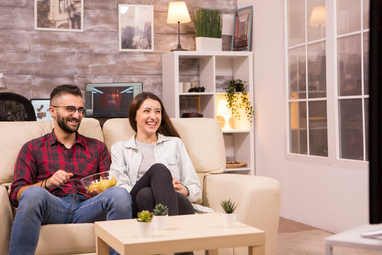 Couple Laughing So Hard While Watching A Movie On Tv