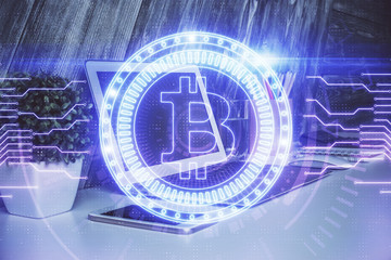 Multi exposure of blockchain theme hologram and table with computer background. Concept of bitcoin crypto currency.