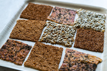 Turkish Homemade Snacks Biscuit with Sunflower Seeds, Sesame and Dill /Crispy Yaprak Galeta with Traditional Tea on Tray.