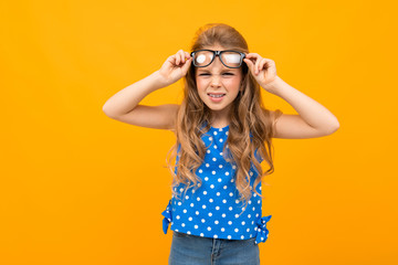 Nice little girl with her glasses isolated on white background