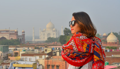 A young woman looking at Taj Mahal