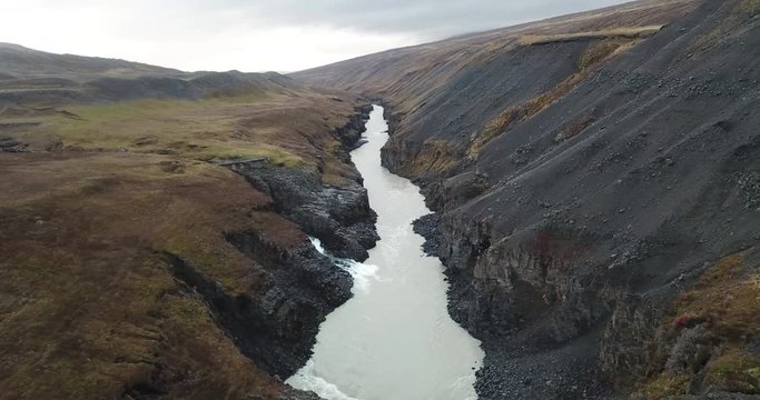 Impressive Iceland Landscape Aerial, Glacier River and Waterfall in Canyon Between Volcanic Basalt Rock Formations